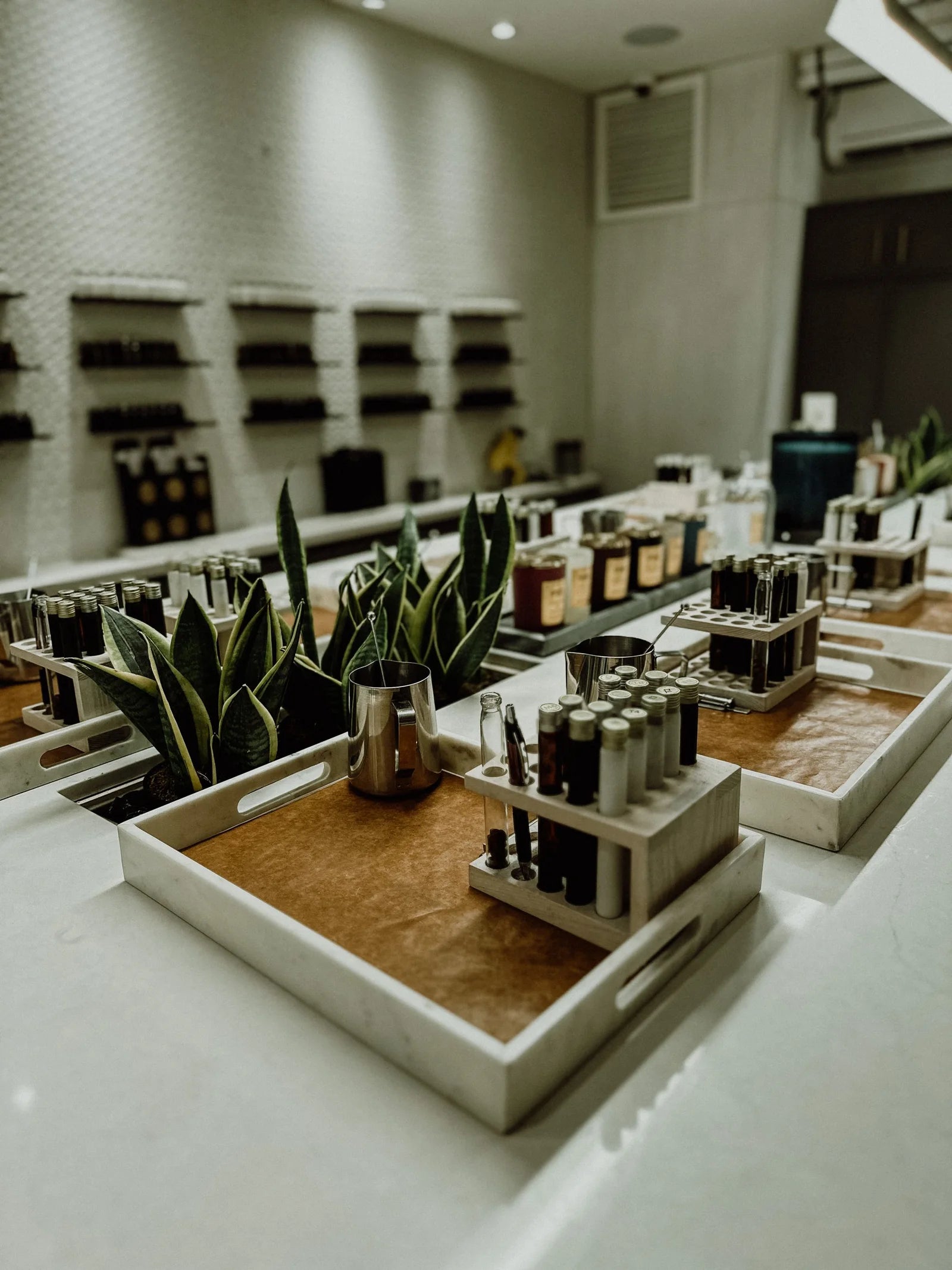 Sample bottles and trays arranged in a bright perfume laboratory